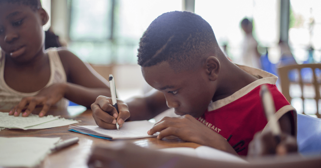 Kids writing intently at a table